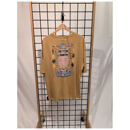 Front view of the Prana Womens Everyday Graphic Oversized Tee-SAMPLE in Dijon Vacation hanging on a grid display with a wooden frame.