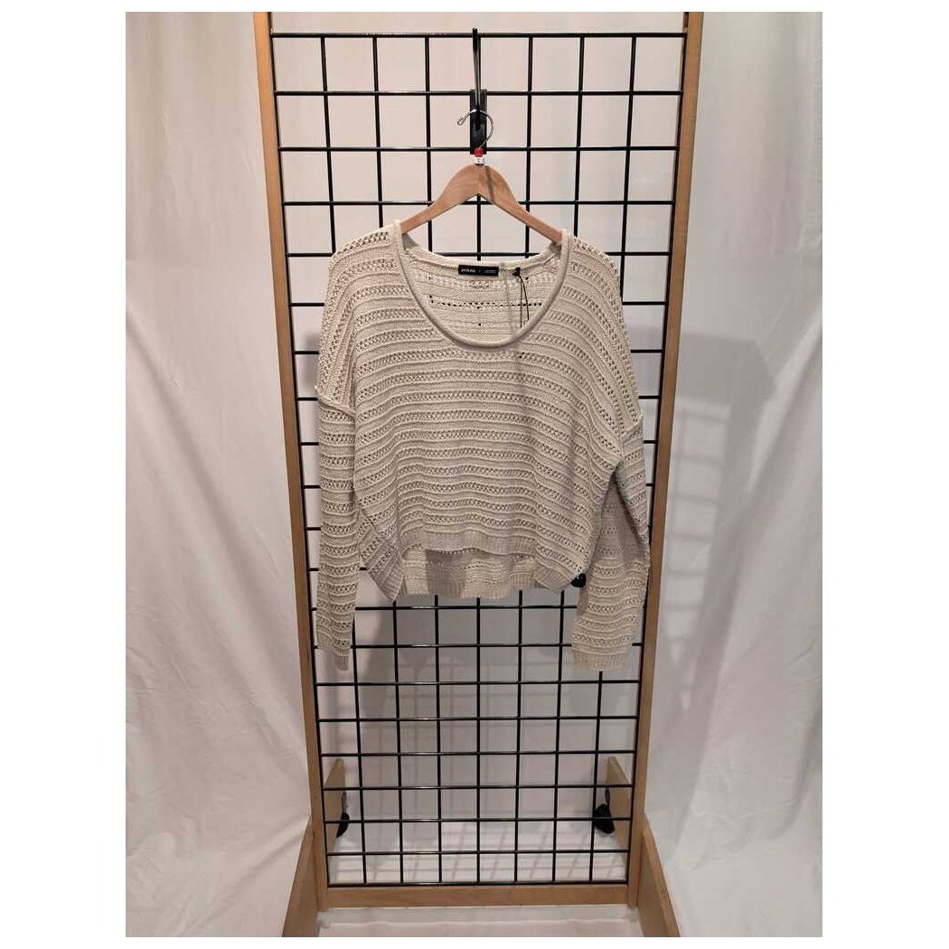 Front view of the Prana Womens Malibu Lagoon Sweater-SAMPLE in Stone Marl hanging on a wooden hanger against a grid display with white drapes.