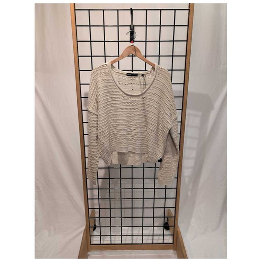 Front view of the Prana Womens Malibu Lagoon Sweater-SAMPLE in Stone Marl hanging on a wooden hanger against a grid display with white drapes.