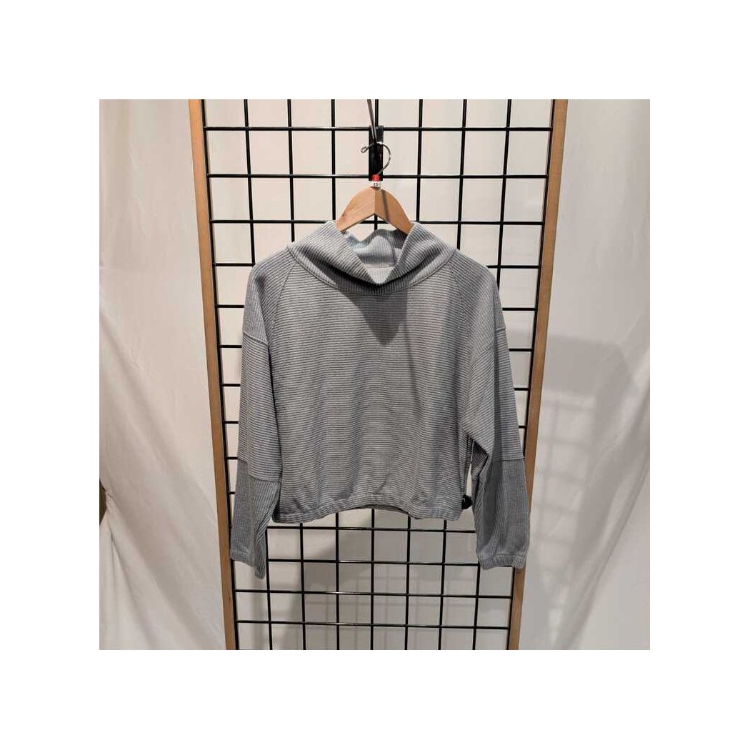 Back view of the Prana Womens Olivia LS-SAMPLE in Quarry hanging on a wooden hanger against a grid background.
