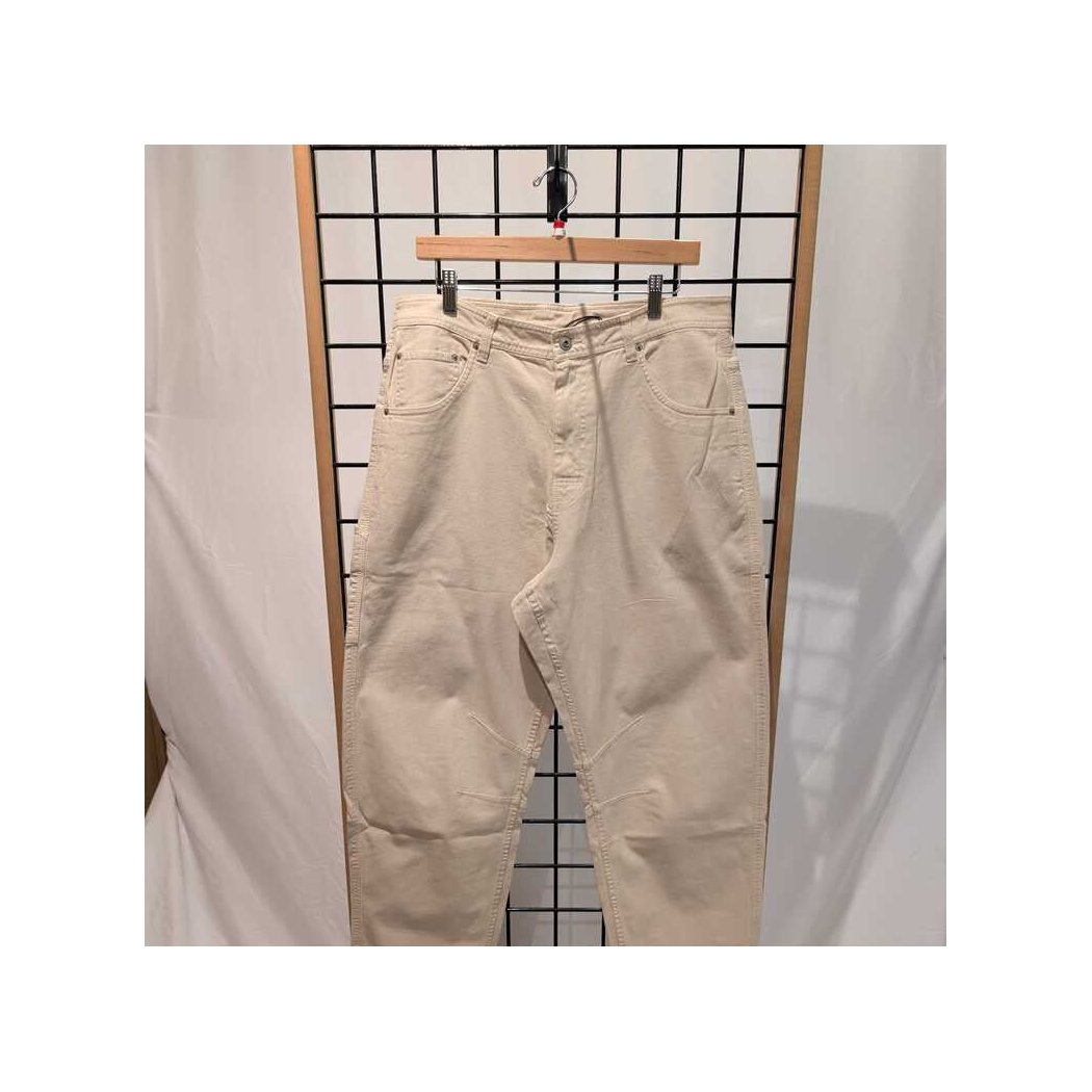Front view of the Prana Womens Rock Ridge Carpenter Pant-SAMPLE in Almond hanging on a wooden hanger against a grid background.