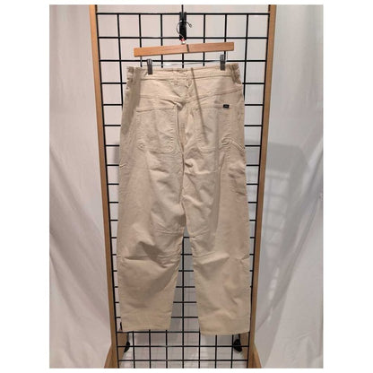 Back view of the Prana Womens Rock Ridge Carpenter Pant-SAMPLE in Almond hanging on a grid display with a wooden hanger.