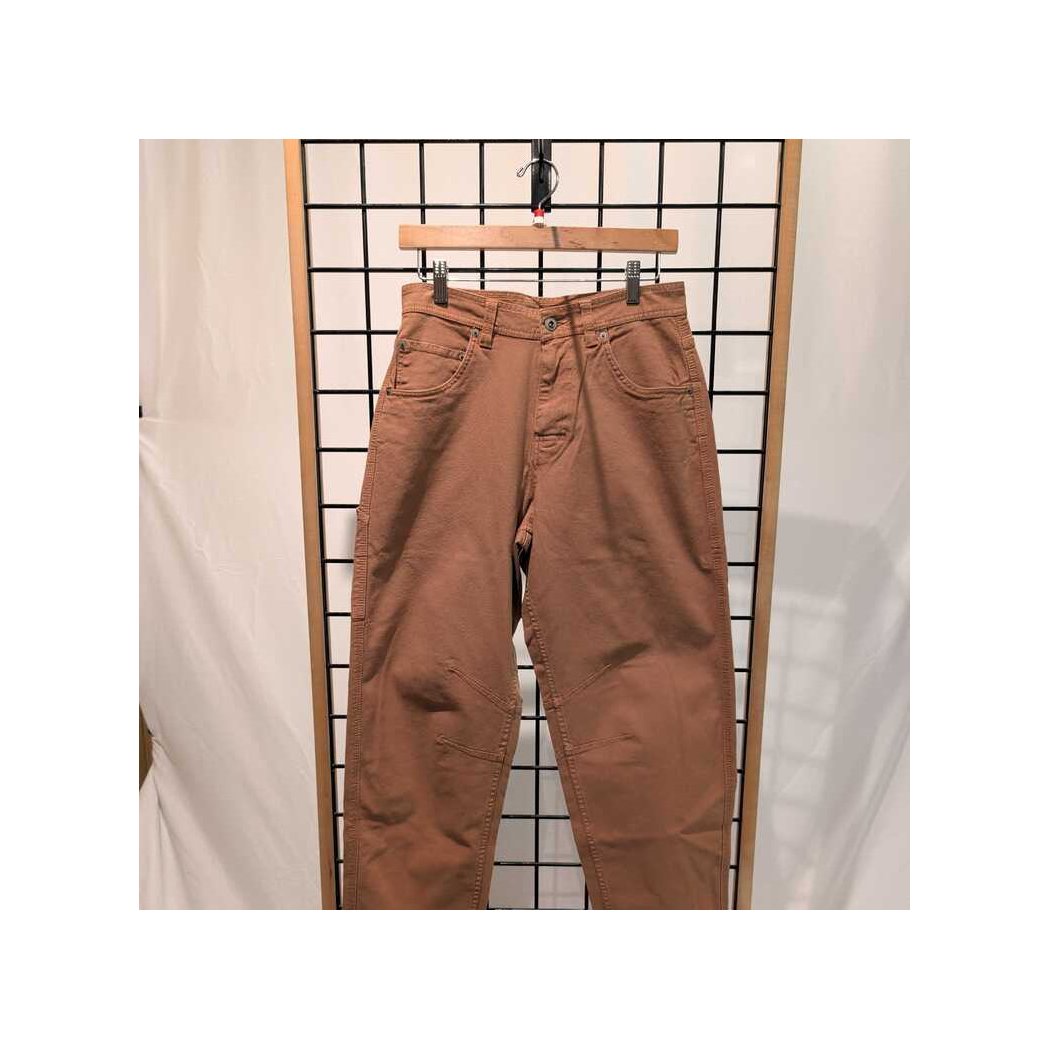 Front view of the Prana Womens Rock Ridge Carpenter Pant-SAMPLE in Almond hanging on a wooden hanger against a grid background.