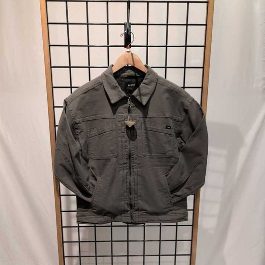 Front view of the Prana Womens Rock Ridge Jacket-SAMPLE in Thyme hanging on a wooden hanger against a grid background.