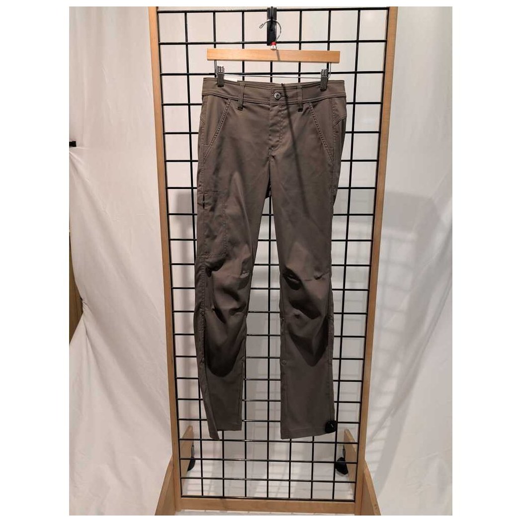 Front view of the Prana Womens Stretch Zion Mid Rise Pant-SAMPLE in Mud hanging on a grid display with a wooden frame.