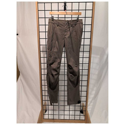 Front view of the Prana Womens Stretch Zion Mid Rise Pant-SAMPLE in Mud hanging on a grid display with a wooden frame.