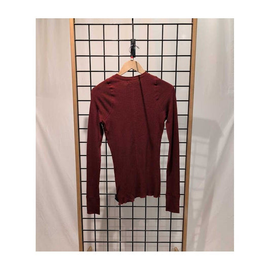 Back view of the Prana Womens Touchstone Henley-SAMPLE in RetrograHeather hanging on a grid display with a wooden hanger.
