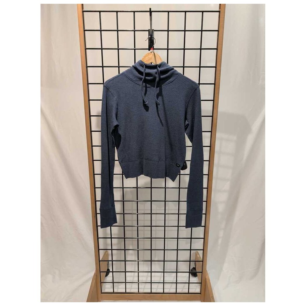 Front view of the Prana Womens Touchstone Hoodie-SAMPLE in Black Heather hanging on a grid display with a wooden frame.