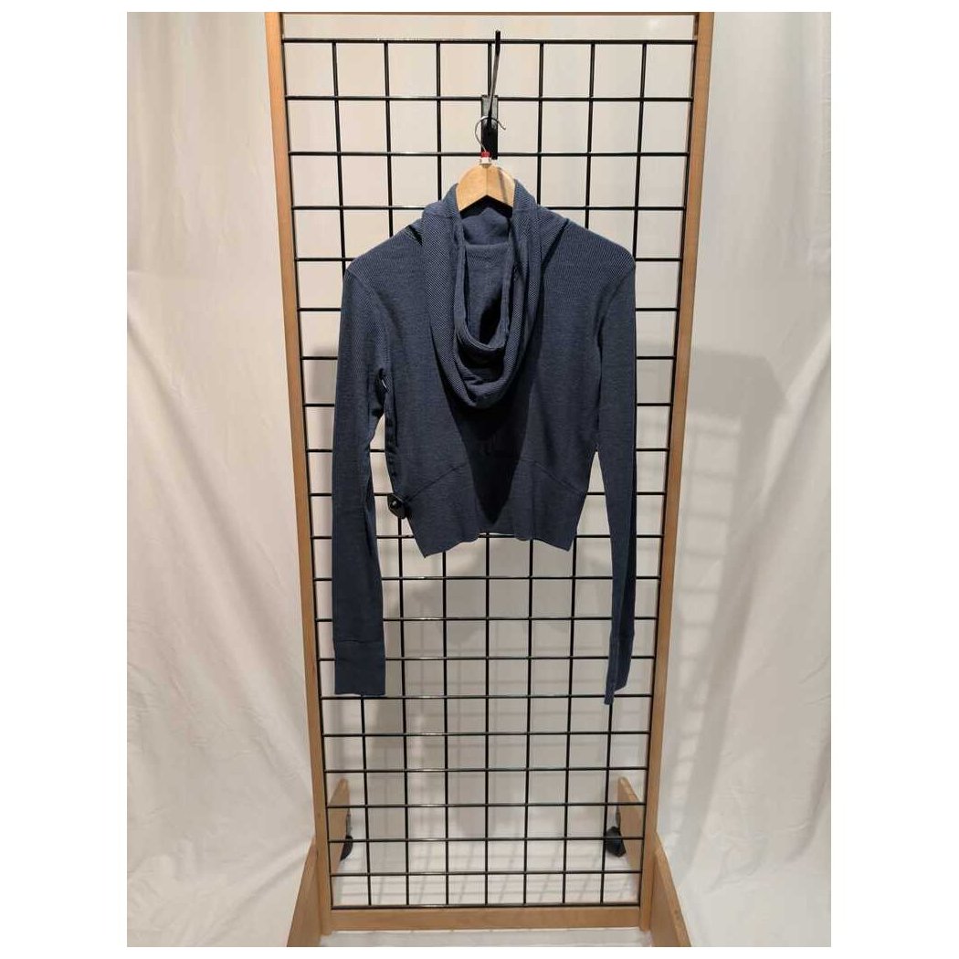 Front view of the Prana Womens Touchstone Hoodie-SAMPLE in Black Heather hanging on a grid display with a wooden frame.