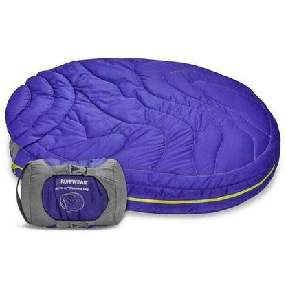 A full view of the Ruffwear Highlands Dog Sleeping Bag in Huckleberry Blue with its gray compression sack visible in front.