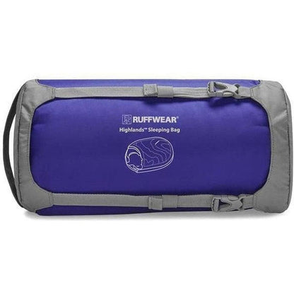 A front view of the Ruffwear Highlands Dog Sleeping Bag in Huckleberry Blue with gray trim and a logo on the front.
