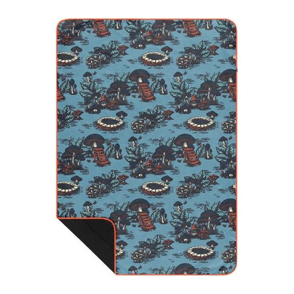 A top-down view of the Rumpl The Everywhere Mat in Coast Retro Rays showing its blue patterned design and orange border.