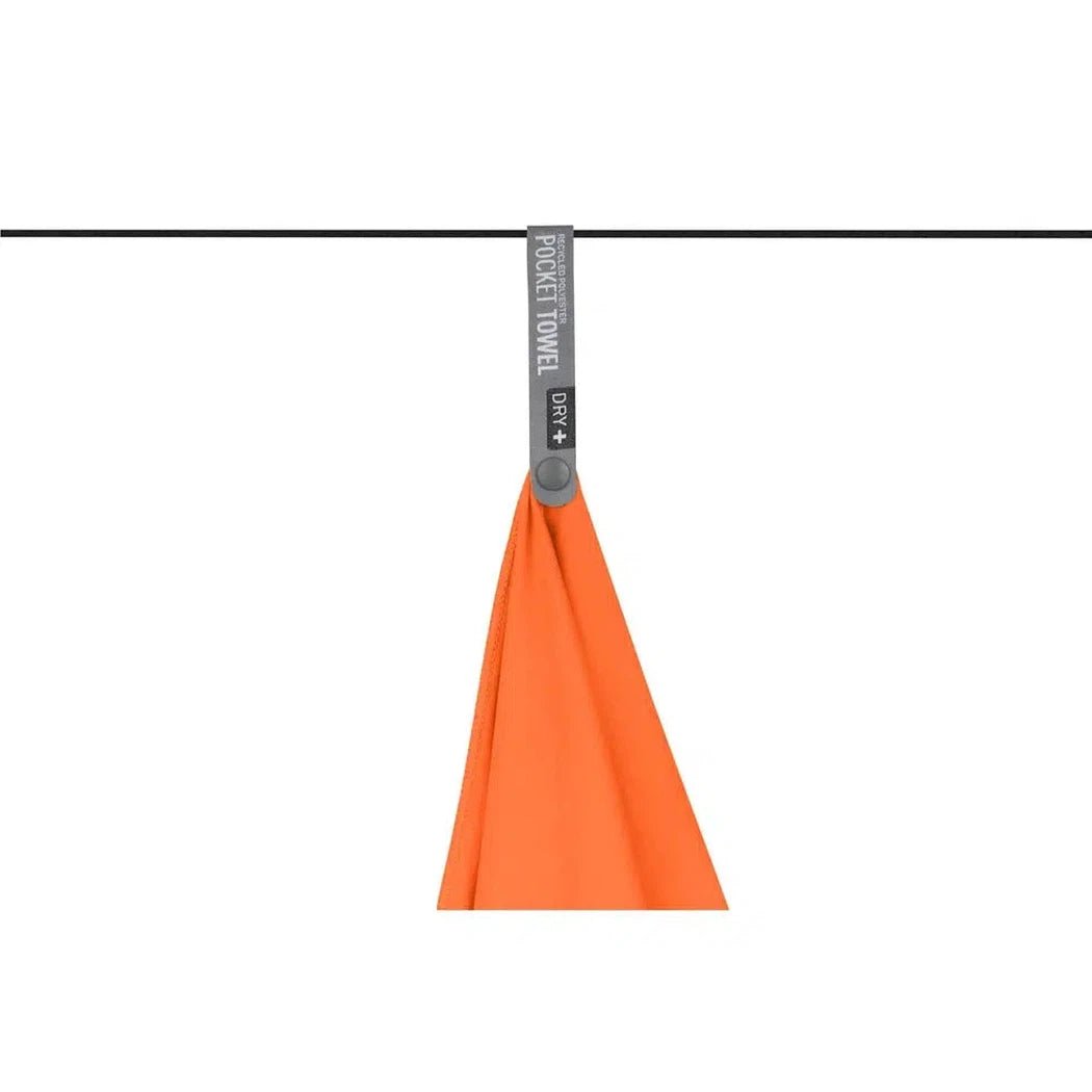 A Baltic Blue Sea To Summit Pocket Towel hangs from a line against a white background.