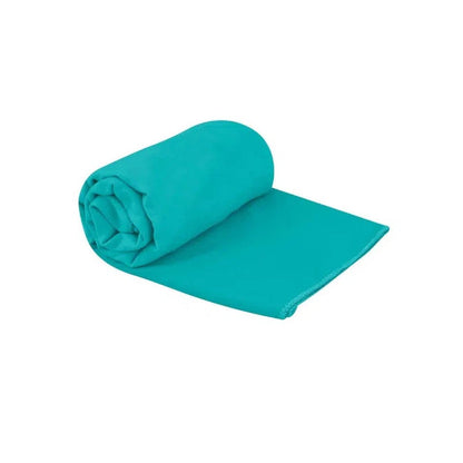 A rolled Baltic Blue Sea To Summit Tek Towel lies flat against a white background.