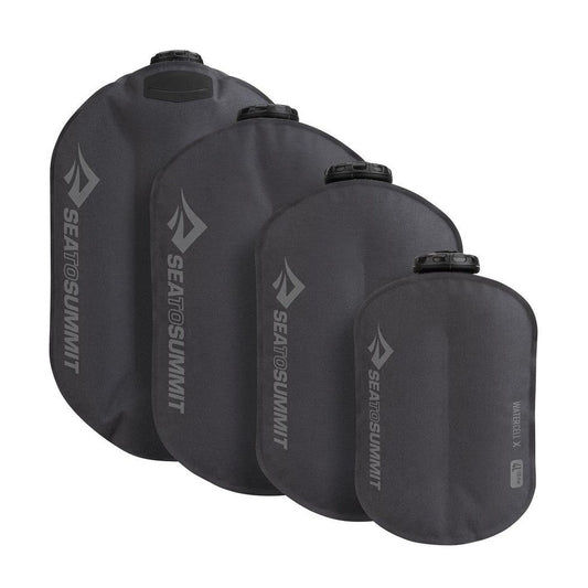 Four Sea To Summit Watercell X hydration bladders in charcoal color, shown from front angle against white background.