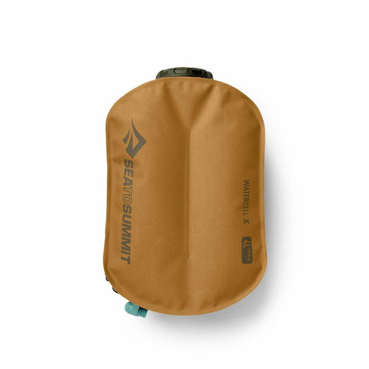 A top-down view of the Sea To Summit Watercell X 4L hydration reservoir in tan, showing the brand logo and a teal valve against a white background.