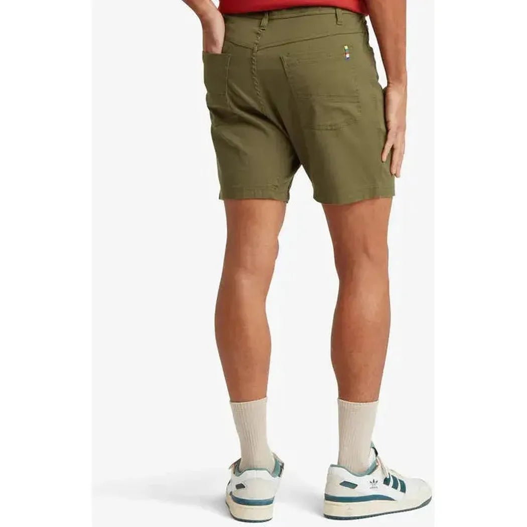 Back view of the Sherpa Adventure Gear Sample - Men's Dando 5 Pocket Short in Evergreen on a model wearing white sneakers against a white background.