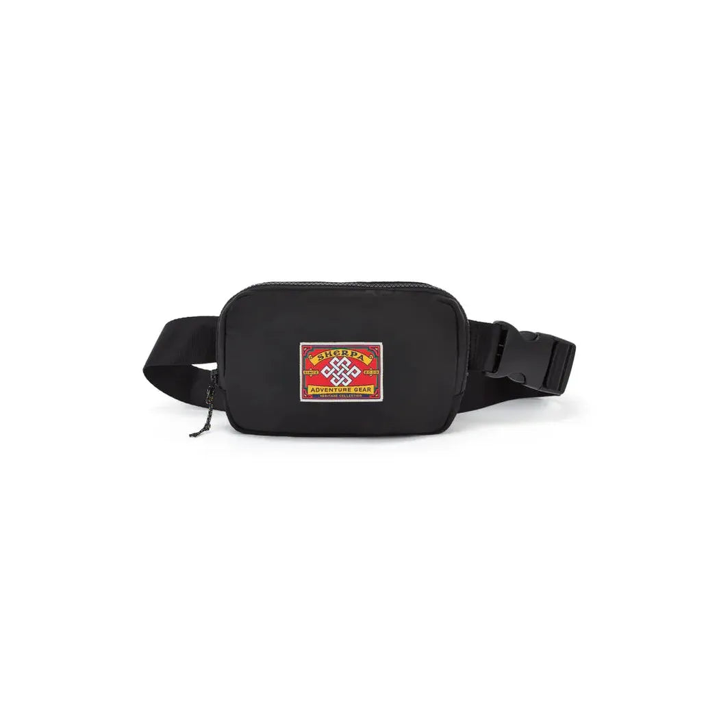 A black Sherpa Adventure Gear Tarcho Belt Bag with a colorful patch on the front, shown from a front angle against a white background.
