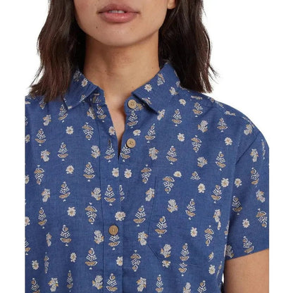 A close-up of the Sherpa Adventure Gear Women's Jaya Camp Shirt in Seaport Blue Indi Blossom, showing the button-down collar and floral pattern on a model against a white background.