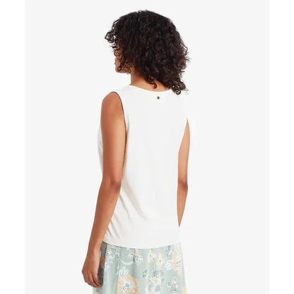 Back view of the Sherpa Adventure Gear Women's Kalindi Tank in Katha White on a model wearing a floral skirt against a white background.