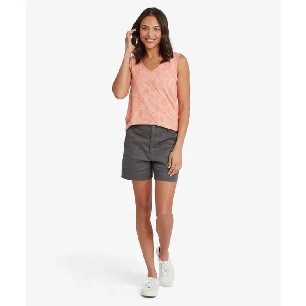 A model wearing the Sherpa Adventure Gear Women's Neha V-Neck Tank in Rose Gold stands against a white background.