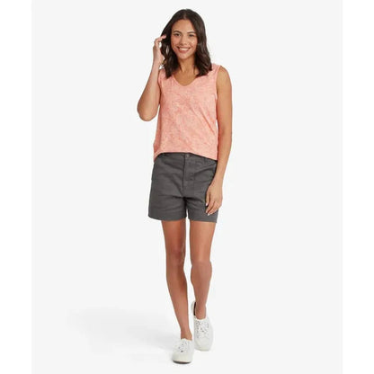 A model wearing the Sherpa Adventure Gear Women's Neha V-Neck Tank in Rose Gold stands against a white background.