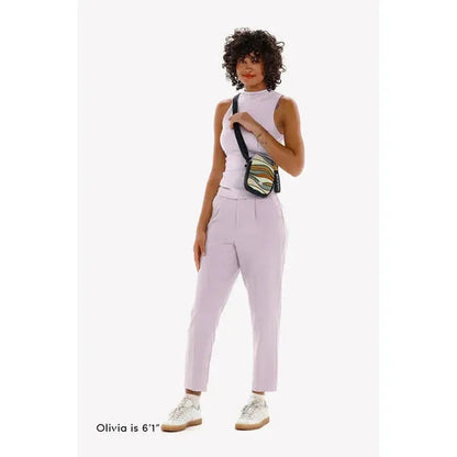 A model wearing the Sherpani Rogue Chromatic crossbody bag stands against a white background.