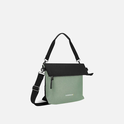 Side view of the Sherpani Vale AT bag in Aloe Mist showing the shoulder strap and front zipper against a white background.
