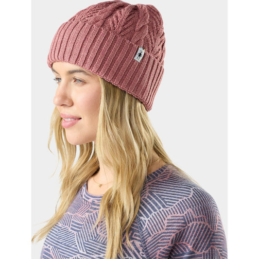 Side view of the Smartwool Cable Knit Beanie in Dusty Teal Heather on a model with long blonde hair against a plain background.