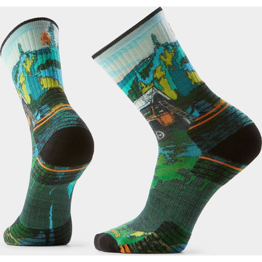 Front and back view of the Smartwool Hike Trail Trekker Print Crew Socks in Winter Moss showing the colorful outdoor print and black heel/toe against a white background.