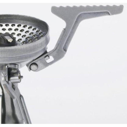 A close-up of the Soto Outdoors Amicus with Igniter stove showing the perforated cooking surface and foldable handle against a plain white background.