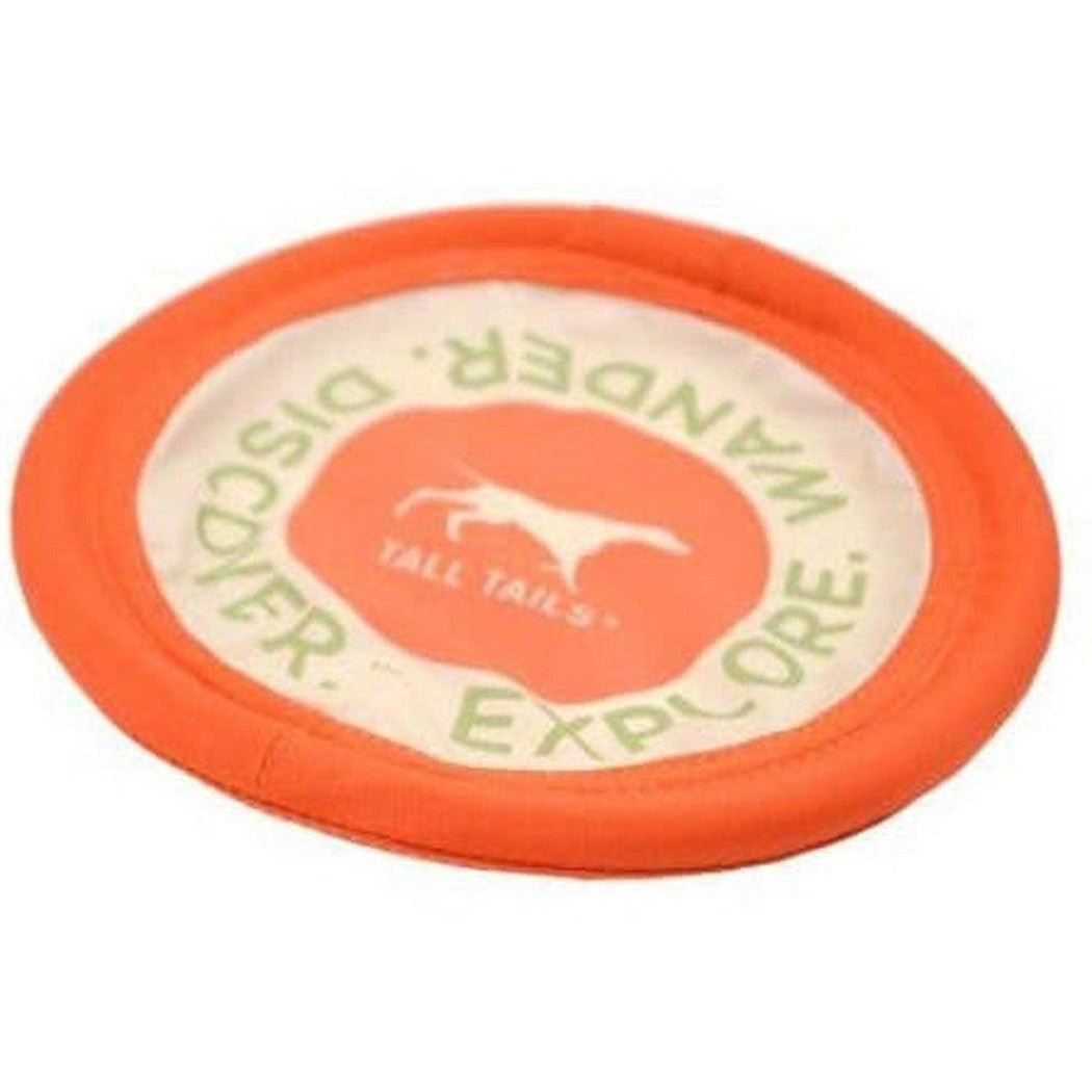 A top-down view of the Tall Tails Soft Flying Disc in orange with "Explore. Wander. Discover." text and a dog logo on a white background.