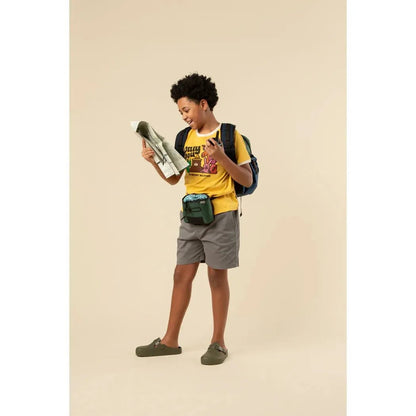 A youth wearing The Landmark Project Only You Vintage Youth Short Sleeve Ringer Tee in Sunshine/Honeycomb looks at a map while standing against a plain background.