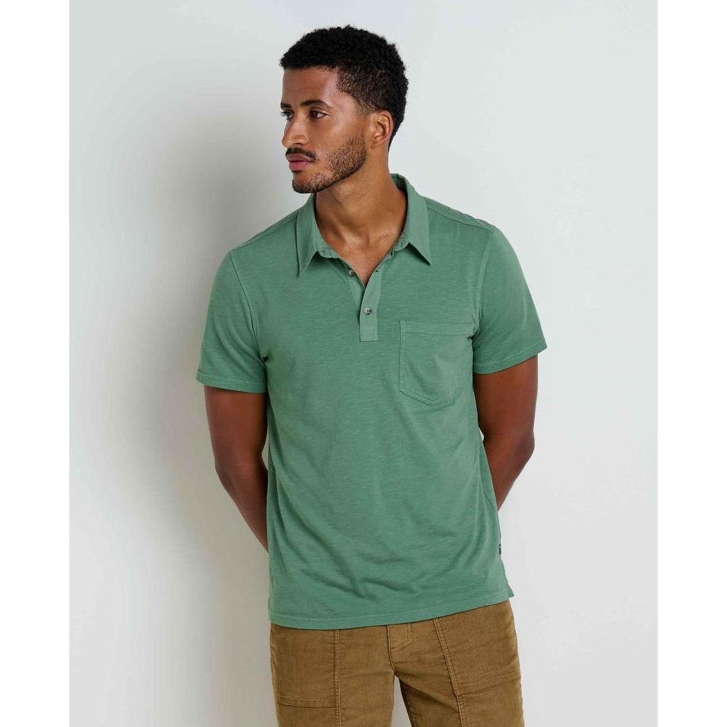 A side view of the Toad & Co Men's Primo Short Sleeve Polo in Ivy, showing the pocket and collar, against a plain white background.