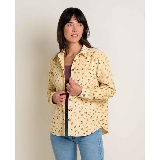A woman wearing the Toad & Co Women's Cascadia Long Shirt in Barley Floral Print stands against a plain white background.