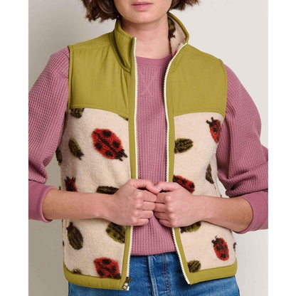 A front view of the Toad & Co Women's Sespe Sherpa Vest in Barley Ladybugs on a model wearing a pink top and blue jeans.