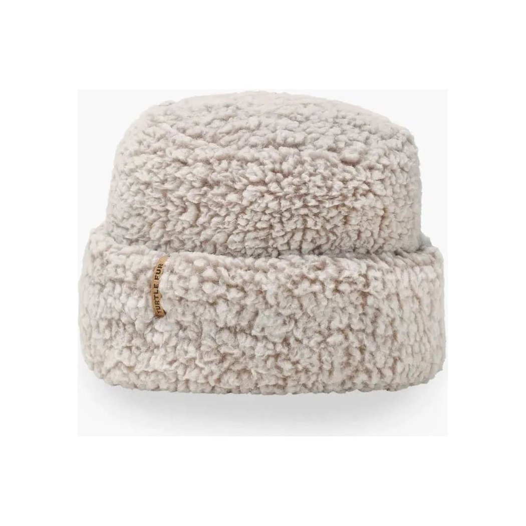 A front view of the Turtle Fur Comfort Lush Après Tort hat in Black with a small gold tag on the brim against a white background.