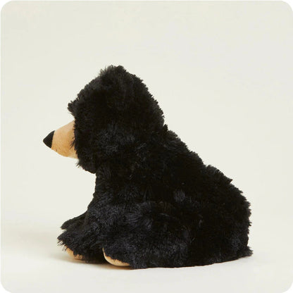 Side view of the Warmies Bear plush toy with black fur and tan accents against a plain white background.