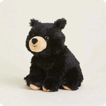 A front view of the Warmies Black Bear Junior plush toy with a light background.