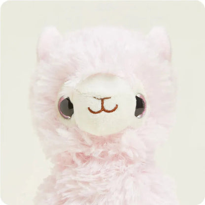 A close-up of the Warmies Pink Llama Junior with large eyes and a soft pink fur texture against a light background.