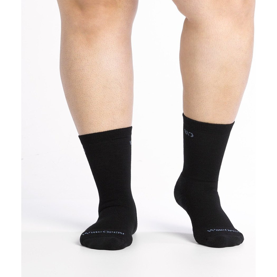 Front view of the Wide Open Women's Solid Cushioned Crew Socks in Black on a model's feet against a white background.