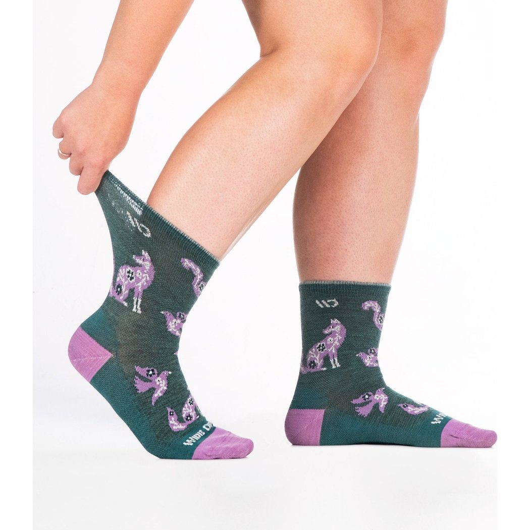 Close-up of a model wearing Wide Open Women's Woodland Wonder No Cushion Micro Crew Socks in Teal with purple accents and woodland animal prints.