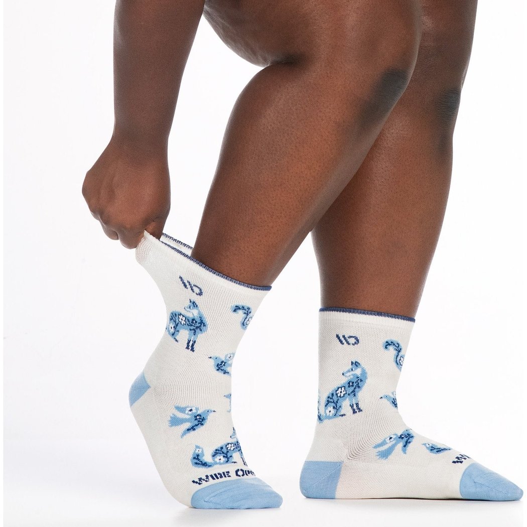 Side view of the Wide Open Women's Woodland Wonder No Cushion Micro Crew Socks in Teal on a model’s feet against a white background.