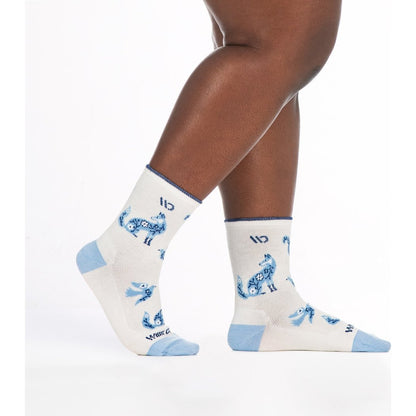 Close-up of a model’s legs wearing Wide Open Women's Woodland Wonder No Cushion Micro Crew Socks in Teal with blue woodland animal prints against a white background.